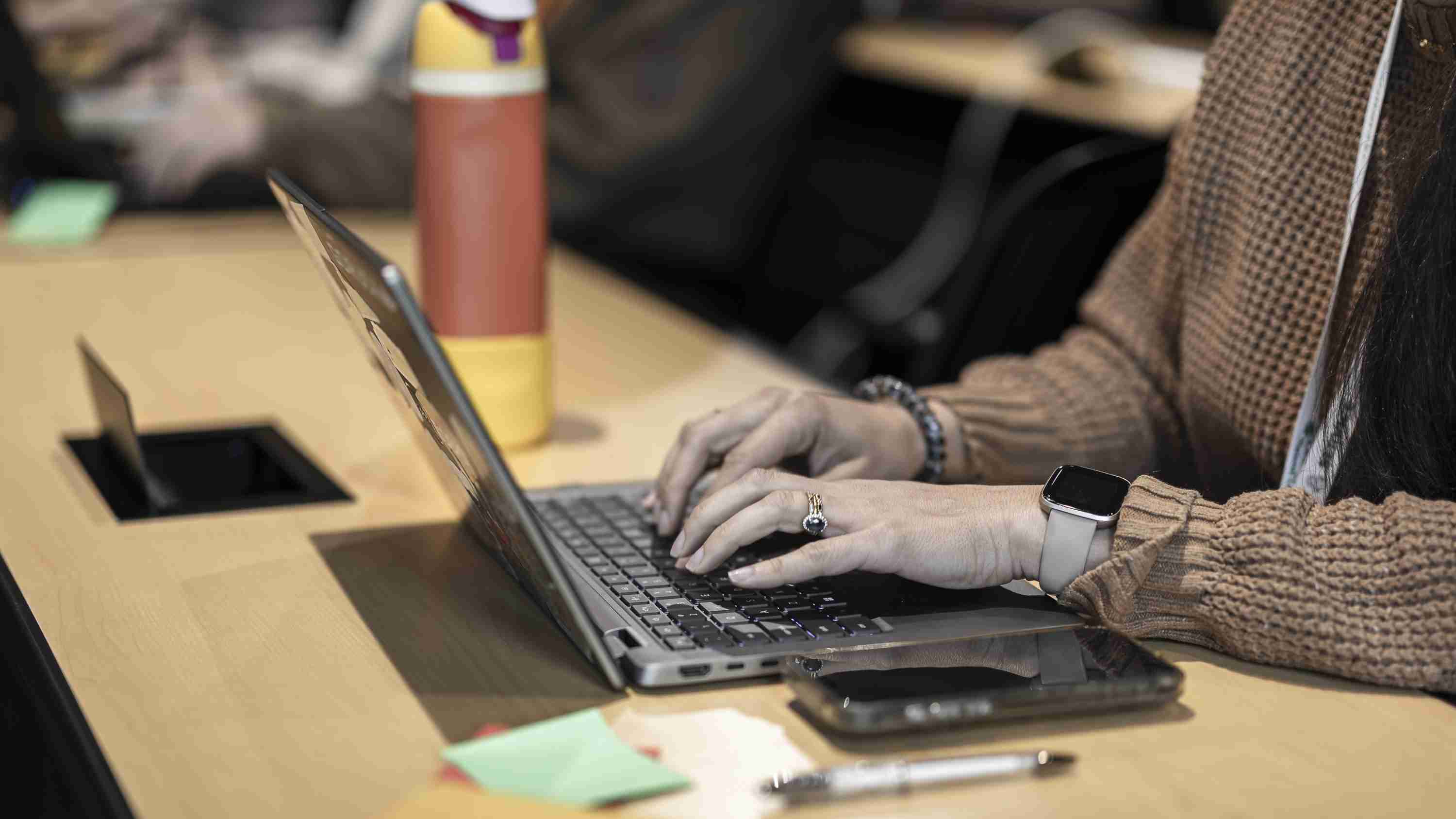 Picture of person typing on a laptop